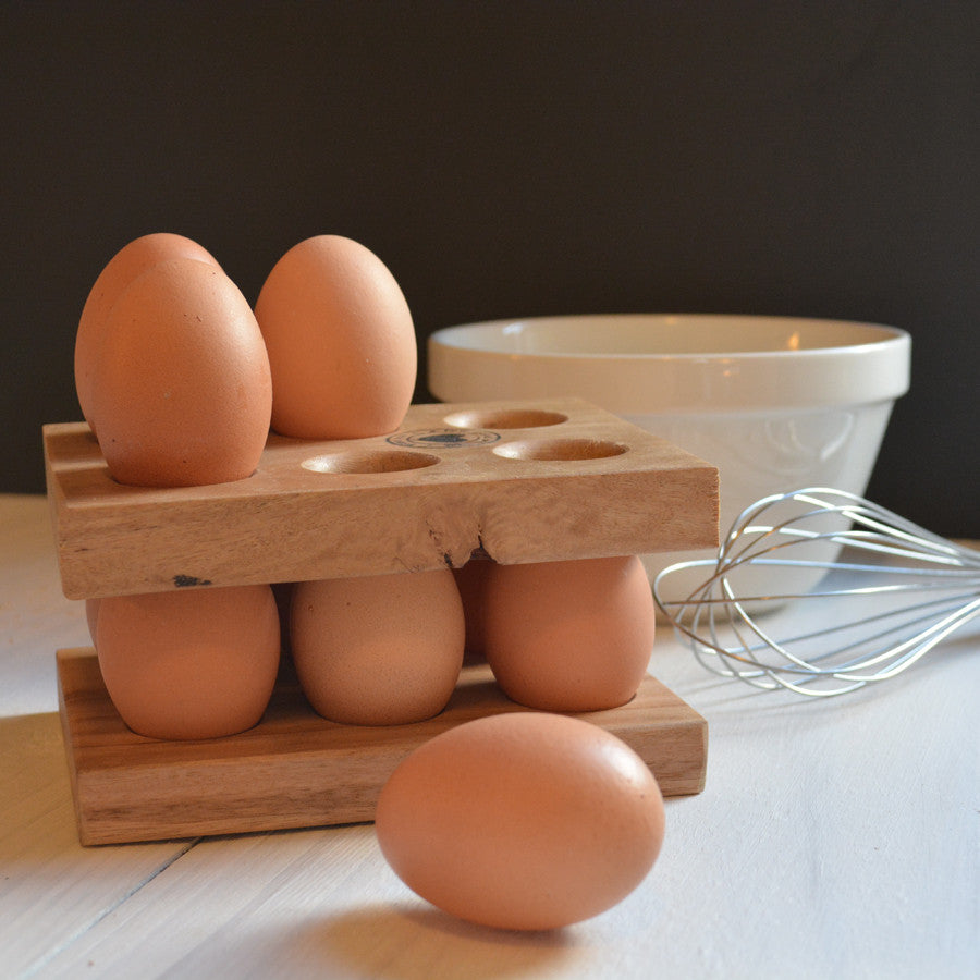 two wooden egg stackers